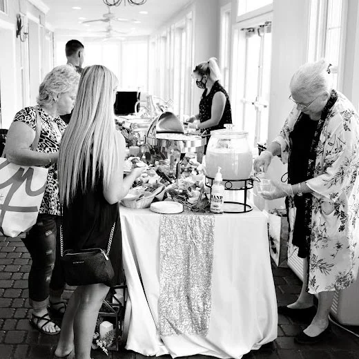 A group of people at a black and white photo buffet.